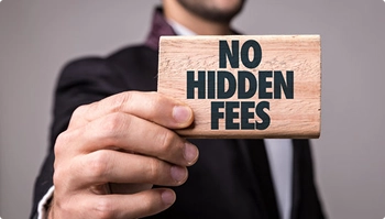 Hand holds wooden sign that reads no hidden fees