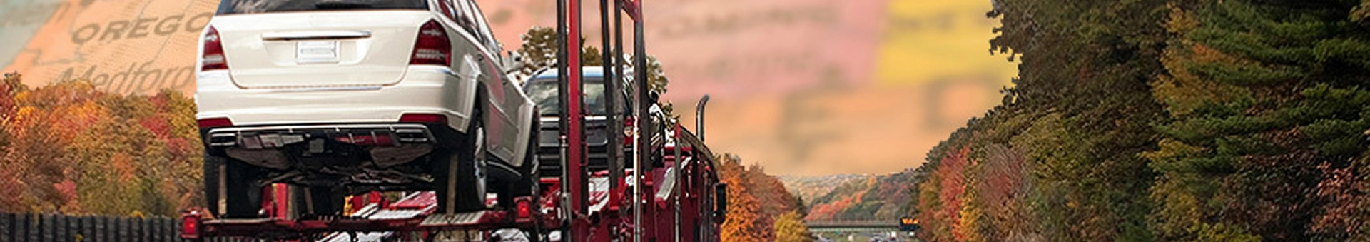 open car carrier hauling vehicles on an interstate during the fall season