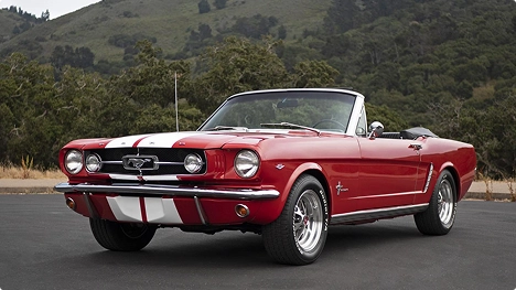 red classic convertible car parked on mountain road representing collector car transport