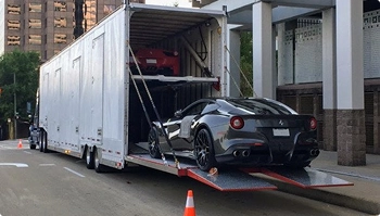 enclosed trailer loading luxury sports cars for secure auto transport
