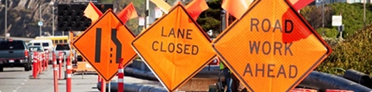 road work and lane closed signs affecting travel time