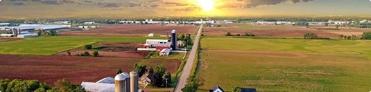 country road through farmland showing rural pickup and delivery