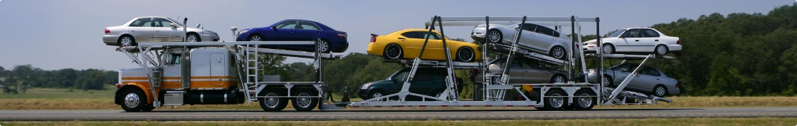 open car hauler truck transporting multiple vehicles across the highway