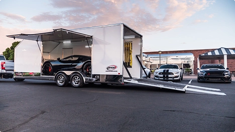 enclosed trailer loading luxury sports cars for safe and secure transport