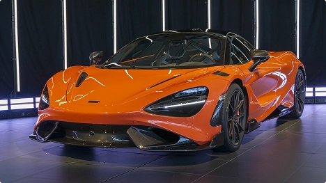 orange exotic supercar under studio lights representing luxury car shipping