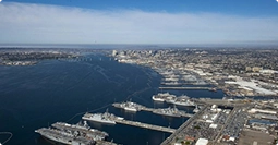 aerial view of naval base and harbor with ships representing military shipping routes