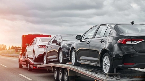 open auto transport trailer carrying multiple vehicles for instant shipping quote without email or phone number