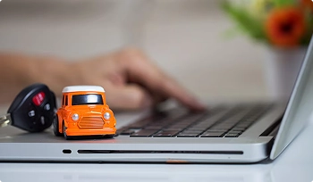 car keys and toy car on laptop showing buy online and ship home