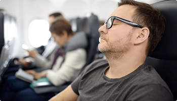 airline passenger seated with carry on illustrating skip the flight option