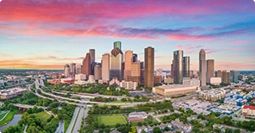 houston to dallas car shipping route with skyline at sunset