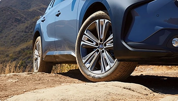 suv wheel closeup driving on dirt road showing offroad vehicle capability