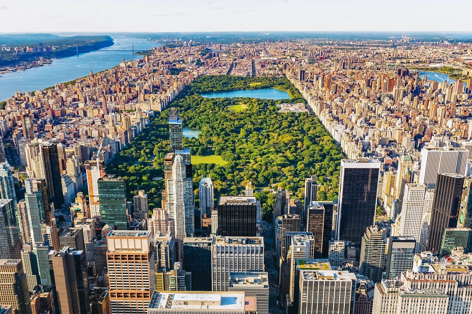 Aerial view of Central Park surrounded by dense skyscrapers in New York City during daylight