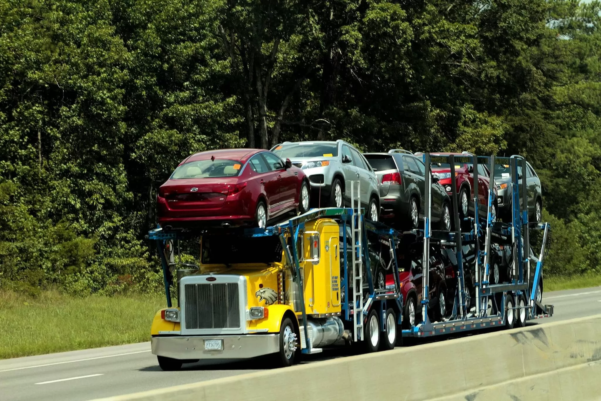auto transport car carrier hauling multiple vehicles on highway