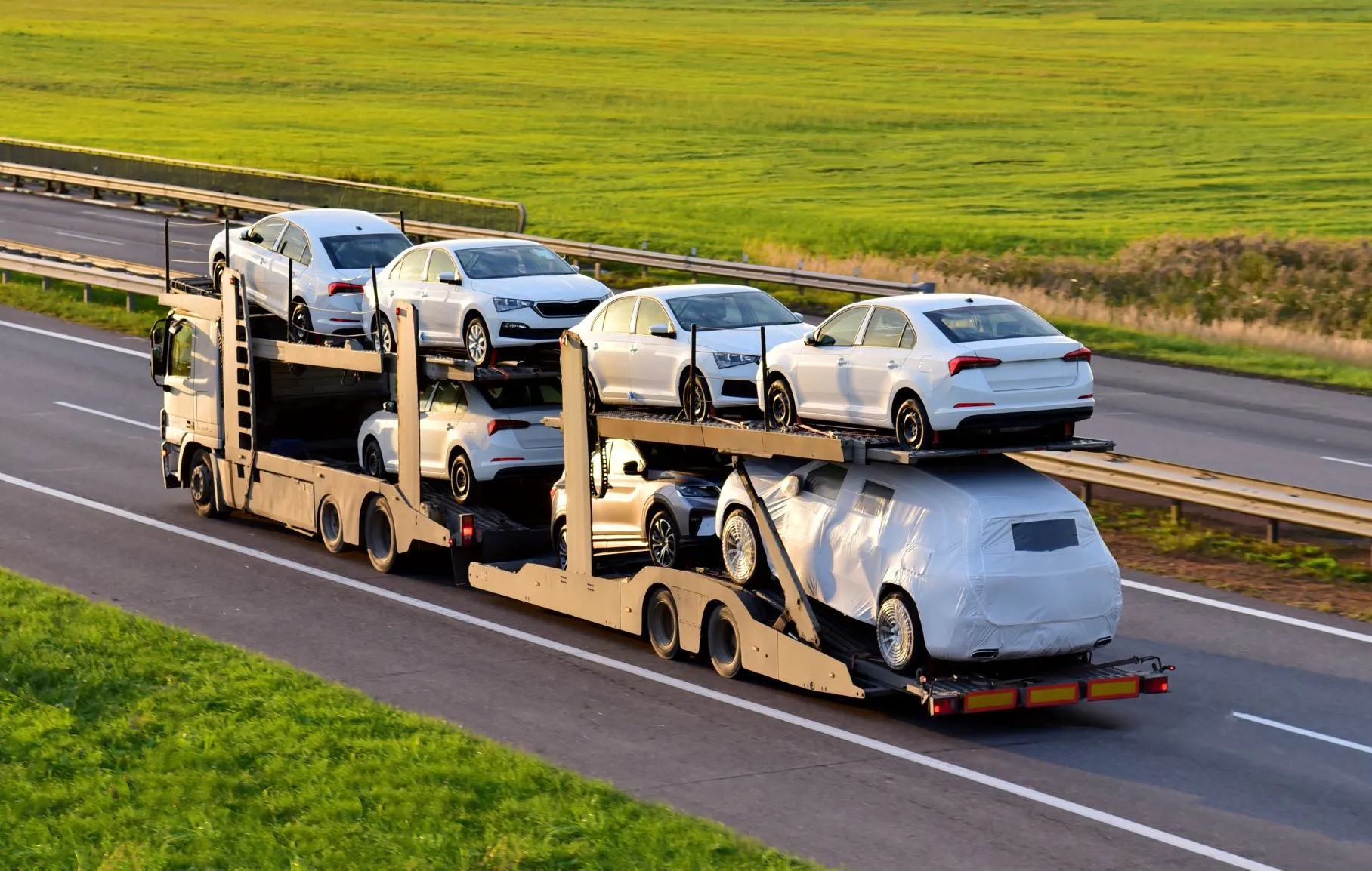 open-car-carrier-hauling-new-vehicles-highway