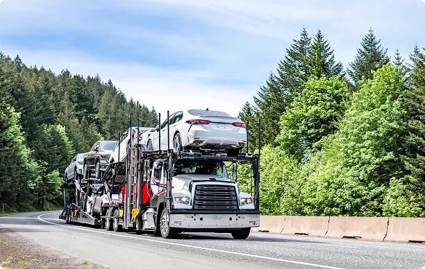 auto carrier truck transporting vehicles on highway for kansas car shipping