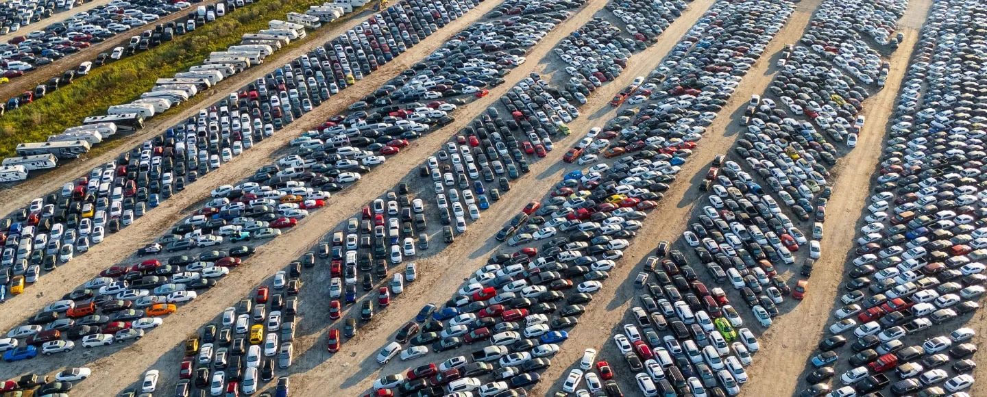 Large auto auction lot filled with rows of vehicles ready for wholesale sale and vehicle transport pickup