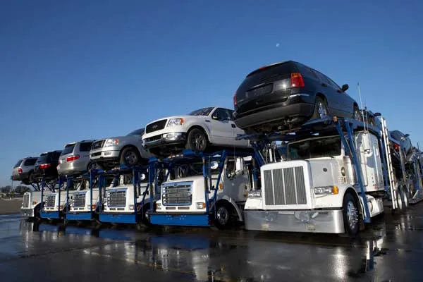 Multi car auto transport carrier loaded with SUVs and trucks ready for long distance vehicle shipping