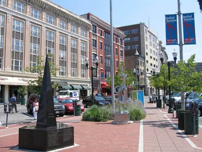 Stamford Connecticut downtown street with shops buildings and pedestrian area representing a major auto transport city