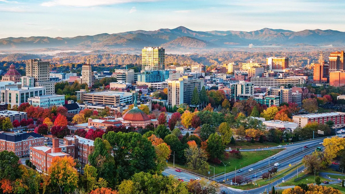 asheville north carolina downtown skyline with fall foliage and blue ridge mountains in the background