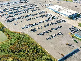 aerial-view-of-an-auto-auction-yard-showing-parked-vehicles-equipment-and-storage-areas-ready-for-transport