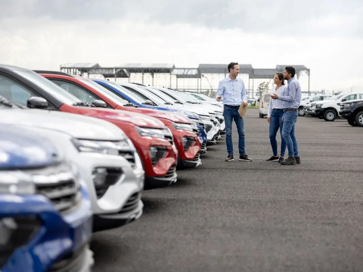 car-auction-buyers-talking-and-inspecting-vehicles-lined-up-on-an-auction-lot-before-purchase-and-transport