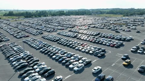 aerial-view-of-a-large-auto-auction-lot-filled-with-hundreds-of-parked-vehicles-ready-for-transport-and-sale